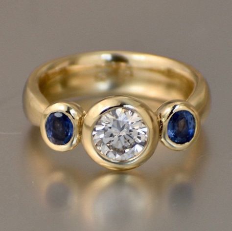 Bezel Moissanite Engagement Ring With Sapphire Side Stones, Heavy 3 Stone Gold Ring, Ethically Sourced Gemstones - Etsy Saphire Jewelry, Engagement Ring With Sapphire, Jewelry Redesign, Stone Gold Ring, Sapphire Side Stones, 3 Stone Engagement Rings, Blue Bell, Right Hand Rings, Custom Ring Designs