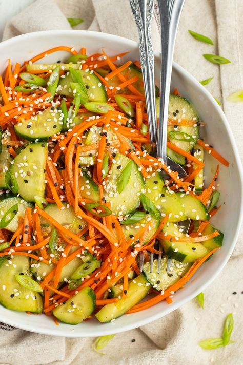 Crisp, and deliciously refreshing, this easy to prepare cucumber and carrot salad is tossed in a tasty soy and sesame dressing. Carrot And Tomato Salad, Asian Carrot Salad, Korean Carrot Salad, Cucumber Carrot Salad, Cucumber Slaw, Plant Meals, Carrot Salad Recipes, Vegan Chinese, Higher Vibration