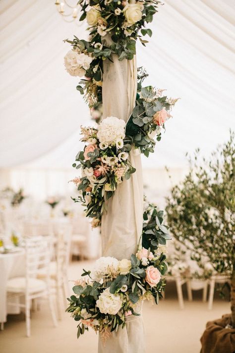 Marquee Poles With Floral Decor Boho Floral Wedding Decor & Bohemian Wedding Decorations - With beautiful peach soft blush pinks floral & elegant floral wreath! Perfect for Fall, Floral & Romantic Weddings! Flowers On Poles Wedding, Post Wedding Party Decorations, Wedding Pillars Decorations, Decorating Marquee Wedding, Decorate Poles For Wedding, Decorating Poles For Wedding, How To Decorate Poles For Wedding, Flowers On Columns Wedding, Wedding Pole Decorations