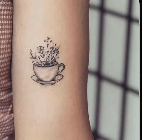 Black and gray minimalist tattoo of a teacup with flowers in it Cup Of Tea Tattoo, Teapot Tattoo, Coffee Cup Tattoo, Tattoo Cafe, Tea Tattoo, Teacup Tattoo, Tattoo With Flowers, Gray Minimalist, Cup Tattoo