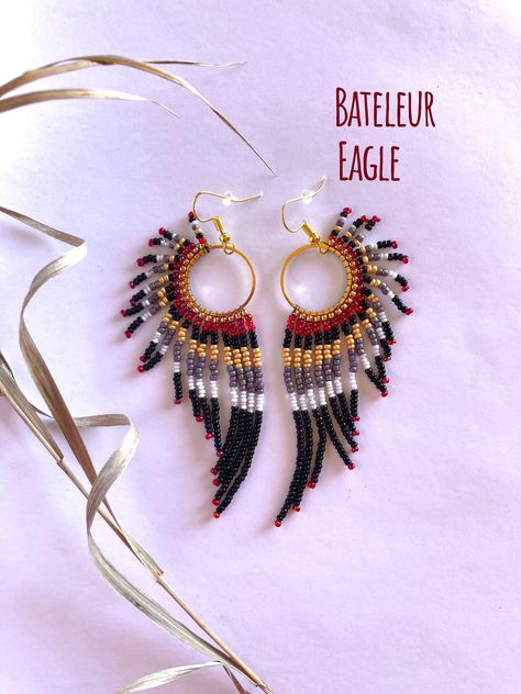 "Handmade, lightweight, durable, beaded dangle earrings. For bird, raptor, and falconer enthusiasts! Bird type: Bateleur Eagle. Native to Africa! Size: Medium hoop size, and just over 3.5 inches total length from hook to end of the longest beaded strand. Hoop size: Medium: 20mm (0.8 inches) Materials: Silver hooks, with White K hoops. Made with glass beads, 6lb mirco-infused Fireline thread, glue, and rubber earring backing. Care instructions included. Processing: Please allow 1-3 days for processing. Shipping: Sent USPS Ground. Delivery time depends on your location. Returns: You may return your item as long as you pay for return shipping. A full refund will be given if the jewelry is returned in the same condition when purchased.  40% of every raptor related sale is donated to the Rocky Handmade Earrings Ideas, Bateleur Eagle, Beaded Feather Earrings, Diy Beaded Earrings, Diy Earrings Dangle, Beaded Feather, Seed Bead Jewelry Patterns, Beaded Jewelry Earrings, Native Beading Patterns