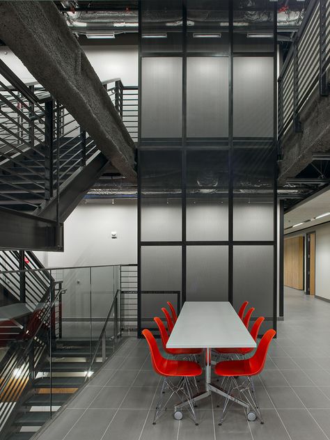 Commerical Office Interior Design | Designed by Replinger Hossner Osolin Architects Red Black And White Office Ideas, Bullpen Office, Black And White Office Ideas, White Office Space, Industrial Luxe, White Office Decor, Black And White Office, Red Chairs, Red Office