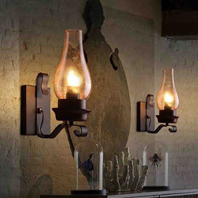 This vintage kerosene lamp shape/ chimney glass sconces design brings a vintage atmosphere to your home. Metal lamp body with matte black finishand and glass lampshade brings country style to your room. Longshore Tides | Longshore Tides Baurzhan Steel (Accents) Armed Sconce 11.8 H x 4.3 W x 7.9 D in black / brownGlass / Metal in Matte Black | 11.8" H X 4.3" W X 7.9" D | Wayfair Stairwell Sconces Lighting, Sconces Living Room Farmhouse, Old Lantern Decor Ideas, Fireplace Sconces Lighting, Lantern Light Fixture, Farmhouse Wall Sconces, Interior Wall Sconces, Country Lighting, Primitive Lighting