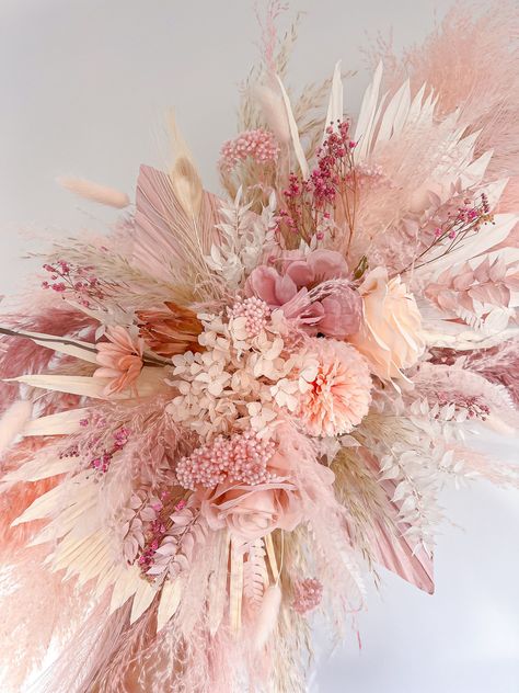 This dried flower decoration includes all the shades of light pink pampas and would be the perfect addition to your baby girls nursery, your salon, in your home or for your wedding! It consists of different shades of light pink fluffy pampas, dried, preserved and artificial flowers and is totally customisable so if you would like to tweak the size or colour please message me and I will be happy to help 😊  It is really easy to install. 2x strong adhesive hooks will be supplied with it which you stick to the wall and hook onto the back of the piece. Size mini = 50cm wide Size medium = 70cm wide  Size large = 90cm wide  The piece in the photo is medium. Please message me if you are requiring it urgently and I will see what I can do. Everything I make is handmade and therefore no two pieces a Pink Pampas Wall Decor, Pink Boho Centerpieces, Pink Boho Wedding Decor, Pink Pampas Grass Decor, Pampas Wall Decor, Pampas Wall, Pink Flower Decor, Pampas Decor, Hot Pink Decor