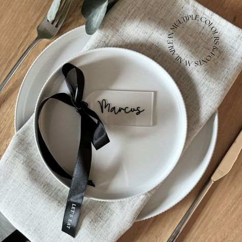 Add a touch of timeless elegance to your special day with our exquisite Black acrylic arch place settings with custom satin bow! Crafted with luxurious black satin ribbon on an arch acrylic card, these name settings will transform your wedding and event decor into a vision of sophistication and charm. Elevate your wedding decor with these stunning accessories and make unforgettable memories. Order now and let your love story shine! Custom arch acrylic bow place settings - the perfect finishing t Wedding Place Settings Black, Black Charger Plates Table Settings, Bow Wedding Decor, Black Charger Plates, Event Table Decor, Acrylic Arch, Acrylic Card, Satin Noir, Wedding Place Settings