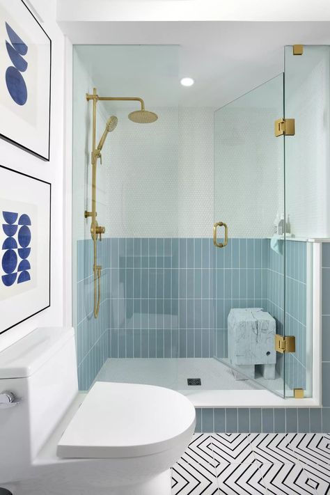 You usually see showers with a single tile installed from floor to ceiling, but this blue shower goes against the grain, boasting a pale blue rectangular tile on the bottom and a white penny mosaic on the top. Think of it as wainscoting, but for your shower. #Bathroom #ShowerIdeas #BlueBathroom #MyDomaine Blue Shower Tile, Blue Bathroom Tile, Wainscoting Bathroom, Unique Shower, Blue Tile, Shower Niche, Gorgeous Bathroom, Basement Bathroom, Small Bathroom Ideas