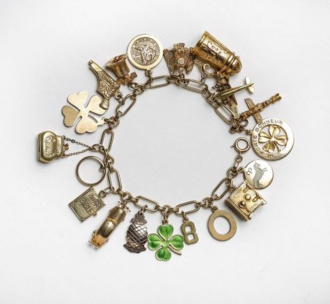 Vintage Charm Bracelet from Lang Antiques and Estate Jewelry. A collection of 14-karat charms, some of which have movable parts. Charms include a beer stein, two lucky clovers, a purse and a safe that opens to reveal a folded $1 bill. Photo: Russell Yip, The Chronicle http://www.sfchronicle.com/style/article/Strike-it-lucky-this-St-Patrick-s-Day-with-6130621.php?t=2699261f56f294ee0d&cmpid=twitter-premium#photo-7619103 Chunky Charm Bracelet, Auction Catalog, Solid Gold Charms, Pearl Drop Necklace, Vintage Charm Bracelet, Turtle Charm, Gold Charm Bracelet, Yellow Gold Bracelet, Handmade Gold