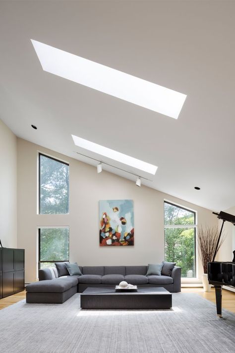 A modern living room with high slanted ceilings, light wells, and tall windows. Single House Design, Slanted Ceiling Living Room, Single House, Slanted Ceiling, Bungalow Renovation, House Design Ideas, Simple House Design, Studios Architecture, Oyster Bay