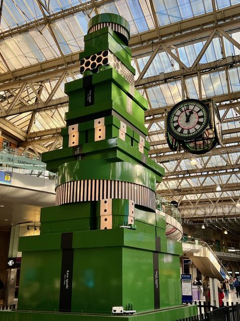 Gazing up at the magnificent Christmas tree inside London’s busiest railway station - London Waterloo Station. It's a 10-metre wonder adorned with Kate Spade Green gift boxes, some playfully decorated in spots and stripes. A working model train set gracefully journeys around the tree across different levels, accompanied by a dazzling light display that illuminates every hour. 🎄🎁🚂✨ 📸 © Ursula Petula Barzey. #BlueBadgeTouristGuide #LetsDoLondon #VisitLondon Waterloo Station, London Overground, Working Model, Kate Spade Green, Model Train Sets, Green Gift, Tourist Guide, Christmas Train, Things To Do In London