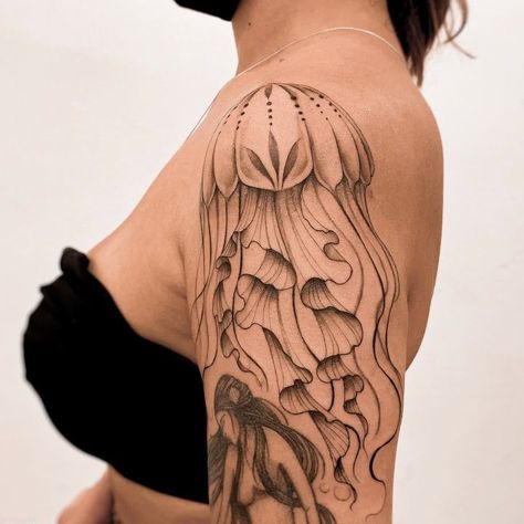 Discover the art of transformation with jellyfish tattoos in our article. Explore it and find 50+ stylish designs with meanings explained. Jellyfish Tattoo Arm Sleeve, Realistic Jelly Fish Tattoo, Jellyfish Arm Tattoos For Women, Shoulder Jellyfish Tattoo, Jellyfish Tattoo Meaning, Jellyfish Shoulder Tattoo, Ocean Tattoos Sleeve Underwater, Tattoos Jellyfish, Medusa Animal