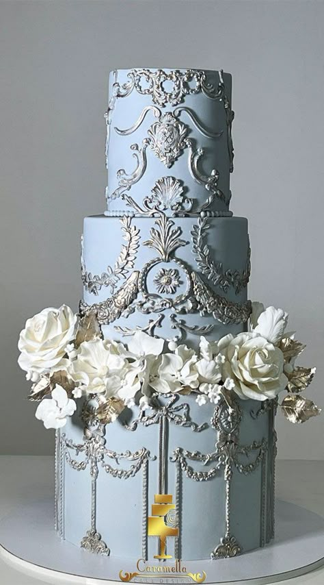 Elegant Bliss Wedding Cake Ideas : Light Dusty Blue and Gold Cake Cool Cakes Aesthetic, Dusty Blue 2 Tier Wedding Cake, Cinderella Themed Wedding Cake, Blissful Wedding Cake, Regal Wedding Cake, Four Tier Wedding Cakes, Greek Mythology Cake, Wedding Cake Light Blue, Dusty Blue Cake