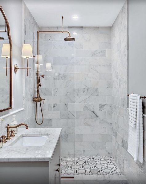 Carrara Venato Bathroom. Created perfectly with minimal amount of actual SKU's for maximum impact. The design used the thin strip Nero Marquina Hexagon along with 6x12" and 6x12" wainscoting and capped with pencil trim. Elegance that will last more than one lifetime! #carraramarble #remodel #showerdesign #shower Teal Basement, Renovation Ideas Bathroom, Soothing Bathroom, Red Bathrooms, Carrara Venato, Bathroom Renovation Ideas, Modern Remodel, Bathroom Redesign, Tiny House Bathroom