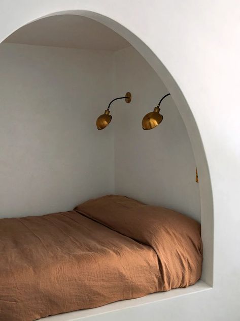 This arched bed nook isn't the only spot perfect for napping in this cozy Spanish-style home. Click through to take a full tour. Small Nook In Bedroom, Bed In A Nook, Bed In Wall Nook, Cacoon Bed, Reading Cubby, Bedroom Nook Ideas, Cocoon Bed, Bedroom Corner Ideas, Sarah Solis