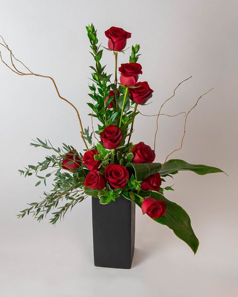 About Rose Amore   We put a twist on the classic dozen roses to create this modern ascending spiral rose design! The Rose Amore oozes elegance and romance. The tower of 12 roses dances with twigs of curly willow and textural greenery in a contemporary matte black ceramic vase.   Approximate dimensions: 14" width, 34" height  roses, medium stem rose, rose, dozen roses, 24 roses, red roses, pink roses, white roses, yellow roses Red Roses Centerpieces, Red Rose Arrangements, Valentine Flower Arrangements, Vasos Vintage, Black Ceramic Vase, Floral Art Arrangements, 12 Roses, Rose Floral Arrangements, Roses Yellow