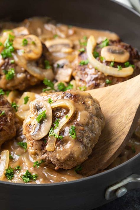 Hamburger Steak smothered in gravy with mushrooms and onions is a hearty and comforting dinner that is quick and easy to make! Hamburger Meals, Smothered Steak, Hamburger Steak And Gravy, How To Cook Hamburgers, Steak And Gravy, Regular Meals, Hamburger Dishes, Fall Dinners, Comforting Dinner