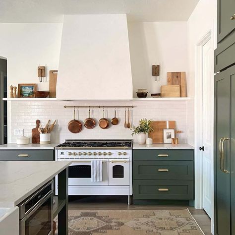 White and gold gas range with white range hood is fitted between sage green kitchen cabinets topped by a white countertop. The cabinets are finished with gold hardware and a white subway tile backsplash. Green Kitchen Island, Dark Green Kitchen, Green Kitchen Designs, Sage Green Kitchen, Green Kitchen Cabinets, Rustic Modern Kitchen, Appartement Design, Green Cabinets, White Countertops