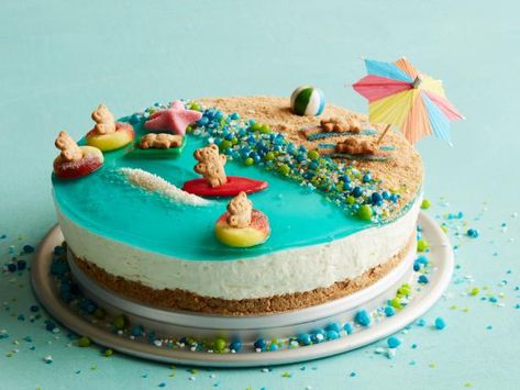 Recipe of the Day: Seashore Cheesecake | Make a splash at your next cookout with this adorable beach-scene cheesecake. Prep the no-bake filling the day before and you'll have plenty of time for the fun part: decorating the graham cracker beach with sea glass candy and floating teddy bears. Top Dessert Recipes, Summer Party Ideas, Savory Cakes, Teddy Grahams, Taffy Candy, Blue Drinks, Cheesecake Recipe, Glass Candy, Colorful Candy