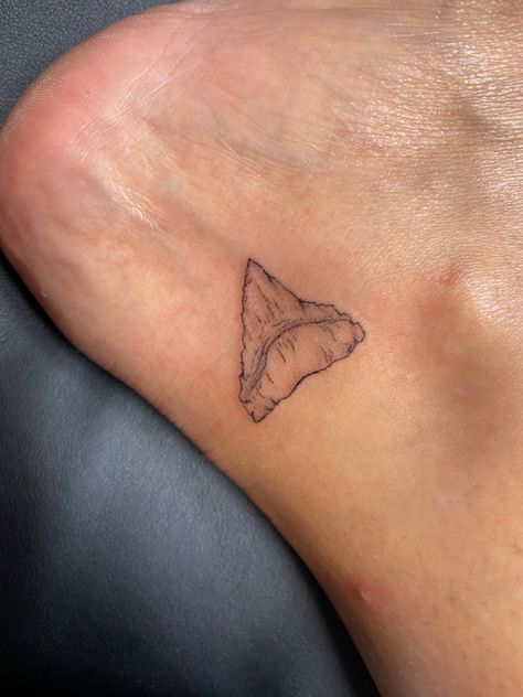 Small shark tooth tattoo on inside of rig HR ankle Hammerhead Shark Tooth Tattoo, Bull Shark Tooth Tattoo, Men Ocean Tattoo, Small Shark Drawing, Fine Line Shark Tooth Tattoo, Tiger Shark Tooth Tattoo, Great White Shark Tooth Tattoo, Sharks Tooth Tattoo, Dainty Shark Tattoo