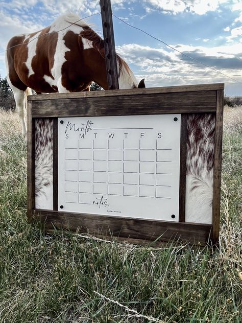 The perfect western calendar that everyone needs!  Handcrafted with premium lumber our signs make the perfect gift, or addition to your own home. We use REAL cowhide. No two signs will be exactly alike. Please note that being a natural cowhide there could be slight yellowing, or marks. Hides can vary! Pictures shown are just an example of the hide color. If you are looking for a specific pattern please message us.  Calendar is 16.75x13.25" and the overall piece is 26x20" Being genuine cowhide no House Decorating Ideas Western, Rustic Classy Home Decor, Cowhide Wall Art, Western Decor Office, Western Dog Room, Vintage Western Decor Bohemian, Western Spare Bedroom, Western Wall Decor Diy, Western Entryway Ideas