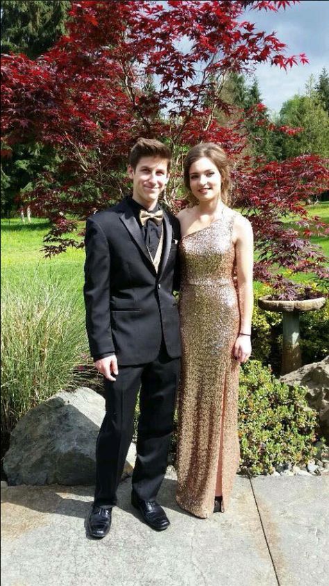 Black Tux With Gold Bow Tie, Black Tux With Gold Accents, Gold Prom Dress And Suit, Black And Gold Tuxedo Prom, Gold Suit Prom, Black And Gold Suit Men Prom, Black Suit With Gold Tie, Gold Prom Tux, Black Suit With Gold Accents