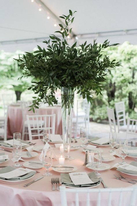 Tall Glass Floral Centerpieces, Green Foliage Centerpieces, Tall Vase With Greenery, Greenery And White Flowers Centerpieces, Glass Bottles Wedding Centerpieces, Tall Eucalyptus Centerpiece, Pilsner Vases Centerpieces, Green And White Flower Arrangements Tall Centerpiece, Greenery Only Centerpiece