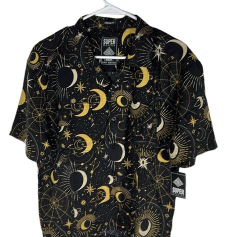 Super Massive Celestial Black & Gold Cropped Fit Button Up Shirt Men’s Size M Length: Approximately 24.5 Inches Pit To Pit: Approximately 22 Inches This Super Massive Button-Up Shirt Is A Must-Have For Any Fashion-Conscious Man. With A Unique Celestial Pattern And Black And Gold Color Scheme, This Shirt Is Perfect For Any Occasion, Whether It Be A Casual Day Out Or A Formal Event. Made From High-Quality Rayon Fabric, This Shirt Is Both Comfortable And Stylish. Featuring Short Sleeves, A Collared Celestial Pattern, Button Up Shirt Men, Conscious Man, Gold Color Scheme, Button Up Shirt Mens, Rayon Fabric, Work Shirts, Shirt Men, Button Up Shirt