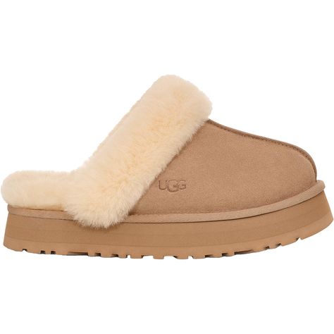 Looking for comfort without sacrificing style? Try the UGG Disquette, a platform slipper with super-soft cushioning, perfect for those early mornings when you need a cozy start. These UGG Disquette Sand Suede Women's Slippers have the following features: Suede Upper Sheepskin Collar and Lining 1" Platform Height EVA Midsole Woven Ugg Labeling Heat Embossed 1122550-SAN Ugh Slipper Platform, Uggs Slippers Platform, Ugh Disquette Slipper, Uggs Slides, Ugg Slip Ons, Baggallini Bags, Athleisure Sneakers, Early Mornings, Clog Slippers