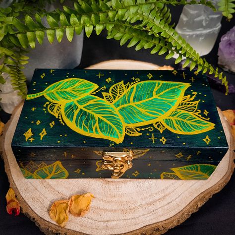 "These fully hand-painted wooden boxes feature my original design of golden leaves on an emerald green base. The boxes are covered with clear high-gloss lacquer to prevent the paint from scratching and for easy cleaning. They are ideal as a jewellery box, pencil case box, DnD dice storage, keepsake, as well as tarot storage, altar decor, ritual and offering box, crystal storage, incense and herbs storage, etc. These boxes can be an excellent custom gift with the personalisation of the inner side of the lid. ► Felt Dividers ADD-ON https://www.etsy.com/uk/listing/1371752802/felt-dividers-add-on-jewellery-crystals ► As the boxes are made to order and completely hand-painted, minor changes to the design will occur. If you have any preferences (i.e. different green colour, change leaf shapes, f Offering Box, Box Pencil Case, Travel Altar, Hand Painted Wooden Box, Painted Wooden Boxes, Painted Jewelry Boxes, Witchy Crafts, Green Box, Stash Box