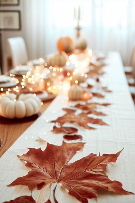 Gather your loved ones and revel in the splendor of autumn with our captivating dining table setting, beautifully adorned with maple leaves and delicate white pumpkins. Elevate your home decor with our exquisite maple leaf garland, infusing your dining space with the cozy warmth and rustic elegance of the season. Embrace the enchantment of autumn and create unforgettable moments around this charming setup. Click now to bring the magic of fall into your home and celebrate the season in style! Autumn Leaves Table Decoration, Simple Fall Party Table Decor, Autumn Dining Table Decor, Parisian Chic Home, Leaf Table Decor, Fall Party Decor, Hype Beast Bedroom, Thanksgiving Table Centerpieces, Baddie Bedroom