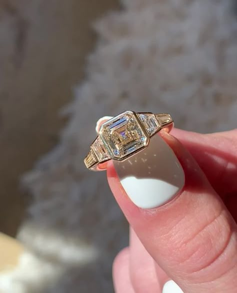 Frank Darling Custom Rings on Instagram: "Our Deco Bullet is named for its namesake bullet shaped side stones– but this time we swapped them out for some thinner tapering baguettes 😍⁠ ⁠ This bezel set beauty features a warm 2.44ct J color asscher diamond made warmer by its 18k yellow gold setting. Bezel set trapezoid and tapered baguettes maximize finger coverage for a look that Gatsby would envy.⁠ ⁠ The Ring:⁠ • 2.44ct Asscher⁠ • J Color, VS1⁠ • 4.25 x 2.25 x 1.5 mm side stones⁠ • 18k YG⁠ ⁠ #f Vintage Bezel Set Engagement Ring, Art Deco Asscher Engagement Ring, Antique Bezel Engagement Ring, Art Deco Bezel Engagement Ring, Retro Engagement Ring, Asscher Bezel Engagement Ring, Engagement Rings Bezel Set, Vintage Asscher Engagement Ring, Vintage Bezel Engagement Ring