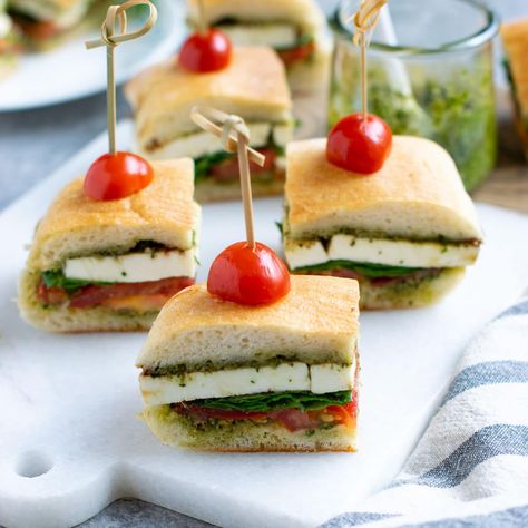 Pesto Caprese Sandwich is an easy vegetarian sandwich recipe for picnics, parties, or potlucks. It features tomatoes, fresh mozzarella, and pesto. #holidayrecipes #partyrecipes #sandwich #vegetarian Mini Veggie Sandwiches For Parties, Appetizer Mini Sandwiches, Caprese Pesto Sandwich, Pesto Tea Sandwich, Veggie Finger Sandwiches, Finger Sandwiches Vegetarian, Dinner Party Sandwiches, Vegetarian Tea Sandwiches Recipes, Caprese Tea Sandwich