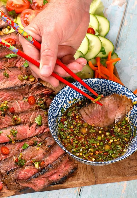 Using chopsticks to dip a piece of steak into the dipping sauce. Crying Tiger Beef Recipe, Tiger Cry Beef Recipe, Crying Tiger Sauce, Crying Tiger Steak, Crying Tiger Beef, Authentic Thai Recipes, Asian Steak, Steak Sauce Recipes, Thai Recipes Authentic