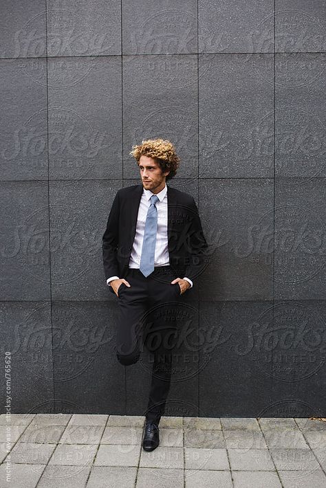 Elegant man leaning against a wall by michela ravasio for Stocksy United Guy Leaning Reference, People Leaning Against A Wall, Someone Leaning Against A Wall Drawing, Man Leaning Against Wall Reference, Guy Leaning Against Wall Reference, Male Leaning Against Wall Pose Reference, Guy Leaning On Wall, Lean Against Wall Pose, Guy Leaning Against Wall