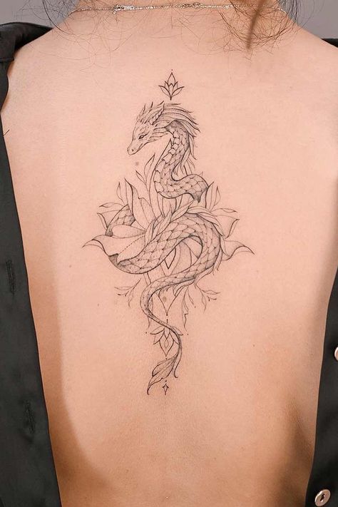 Dragon tattoos symbolize strength, wisdom, and transformation. Explore enchanting designs and unleash your creativity at Glaminati.com. #glaminati #dragontattoo #dragontattoos #femaledragontattoo #dragontattoodesign #tattooideas Dragon Tatoos Woman Back, Aquarius Dragon Tattoo, Dragon Tattoo On Leg Women, Dragon Ribcage Tattoo, Wispy Dragon Tattoo, Futuristic Tattoo Ideas, Ornamental Dragon Tattoo, Dragon Tattoo Back Women, Japanese Dragon Tattoos Women