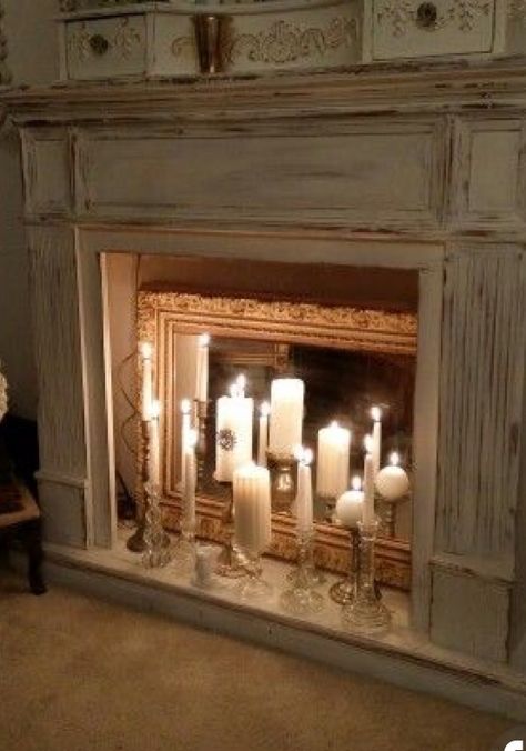 Candles reflected on mirror in fireplace. So romantic! Mirror In Fireplace With Candles, Fake Fireplace Candles, Fireplace Candle Ideas, Diy Candle Fireplace, Old Fireplace Decor, Mantle With Candles, Candles Mantle, Fireplace With Candles, Candles Fireplace