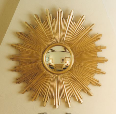 Bursts of fully sculpted antique gold leaf rays radiate a fiery light from an inner convex mirror. The sunburst signature of the French "Sun King" Louis XIV became a popular motif in Spain and throughout Latin America as well. Please note this mirror is available in two sizes (#35) 36" and (#36) 48". Gold Sunburst Mirror, Sunburst Wall Art, Sun Mirror, Golden Decor, Starburst Mirror, House Beautiful Magazine, Gilded Mirror, Gold Sunburst, Convex Mirror