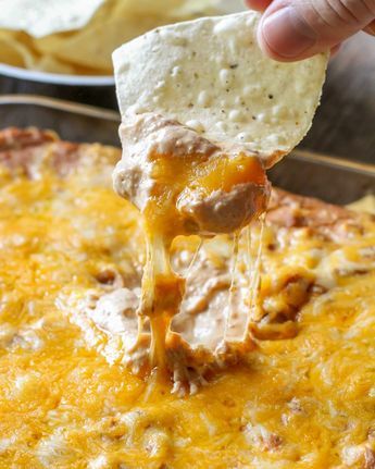 This Cream Cheese Bean Dip recipe is our new favorite Mexican dip! With sour cream, cream cheese, Mexican cheese, refried beans, and salsa, it is the perfect dip to eat with chips, tacos, or any other Mexican dish! SOO good!! Cheese Bean Dip, Cream Cheese Bean Dip, Bean Cheese Dip, Chip Dips, Refried Bean Dip, Bean Dip Recipe, Best Dip Recipes, Bean Dip Recipes, Black Bean Dip