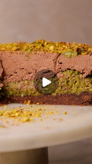 Rosie Brown on Instagram: "Pistachio Crunch Chocolate Cheesecake 🤎  Inspired by the viral Dubai chocolate bars, this cheesecake has a buttery biscuit base layered with pistachio butter and crispy toasted filo pieces. Covered in a thick chocolate pistachio cheesecake and crushed pistachios, every single bite is so creamy but also cirispy with a gorgeous nutty creamy flavour.    INGREDIENTS Base 300g chocolate biscuits, ground to a fine crumb (e.g. oreo, bourbon biscuits) 100g dairy free / dairy butter, melted Filling 200g pistachio paste / butter 1 tbsp butter 200g filo pastry sheets, cut into small pieces Cheesecake 270ml dairy free / dairy double cream 400g dairy free / dairy full fat cream cheese, room temp 100g dark chocolate, melted 100g icing sugar 100g pistachio butter INSTRUCTIONS Chocolate Pistachio Dessert, Biscuit Base Desserts, Dubai Chocolate Cheesecake, Dubai Chocolate Recipe, Dubai Recipes, Pistachio Chocolate Cake, Pistachio Crunch, Crushed Pistachios, Dubai Chocolate