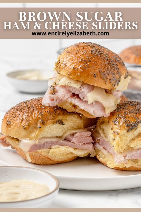 Prepare to be amazed by these outrageously delicious Brown Sugar Ham and Cheese Sliders, featuring savory ham, melted Swiss cheese, and a secret sauce, all encased in toasty buns. Entirely Elizabeth, Sugar Ham, Ham And Swiss Sliders, Easter Drink, Brown Sugar Ham, Savory Ham, Ham And Cheese Sliders, Make Brown Sugar, Brioche Rolls