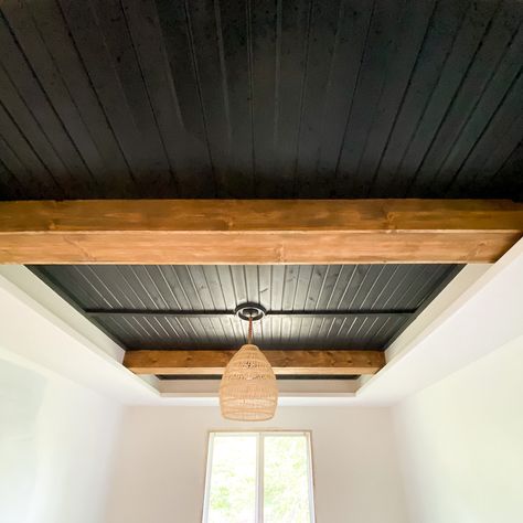 Looking for ideas to turn your tray ceiling into a focal point? By simply adding beams and carsiding, you can change the look of an entire bedroom, family room, kitchen, etc. Check out this post for a full DIY tutorial on how to turn your tray ceiling into a statement. Wood Beam Tray Ceiling, Half Vaulted Ceiling With Beams, Basement Tray Ceiling Ideas, Tiny Home Rustic Interior, Wood Ceiling In Dining Room, Painted Wood Ceiling With Beams, Dining Room Tray Ceiling Ideas, Shiplap Entire Room, Black Stained Wood Ceiling