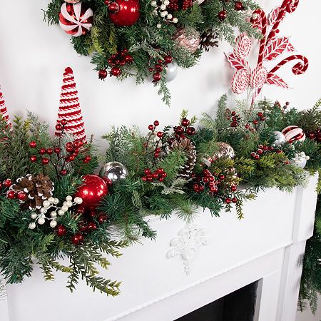 Add some green to your mantelpiece with this gorgeous mix foliage decorated garland. Its pine branches come decorated with pinecones red and white ornaments and berries. This festive garland includes a bendable wire center and metal loops on each making decorating for the holidays a breeze. Product features: unlit. Accented with pinecones various ornaments and berries. A bendable wire center allows you to shape the garland any way you desire. Recommended for indoor use only. Dimensions: 6' long… Modern Fireplace Christmas Decor, Holly Christmas Decorations, Christmas Mantel With Tv, How To Hang Garland Around Doorway, Christmas Shelves Decor, Garland Over Doorway, Christmas Berry Decor, Old Fashion Christmas Decorating Ideas, Indoor Christmas Garland