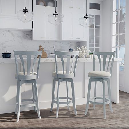 The pieces we accent our kitchen and dining spaces with are like jewelry for our rooms. With this transitional counter stool, get that extra something special that pulls together the whole look. Sturdily crafted with durable wood in a blue wire brush finish, the classic-yet-modern lines of this bar stool rise to greet a cozy 360-degree swivel seat covered in a neutral cream upholstery that is as easy to clean as it is comfortable. Plus, a vertical curved slat back design gives this stool the imp Colored Bar Stools, Kitchen Island Stools With Backs, Transitional Counter Stools, Nola House, Colorful Bar Stools, Blue Bar Stools, Counter Stools With Backs, Studio Apartment Living, Island Stools