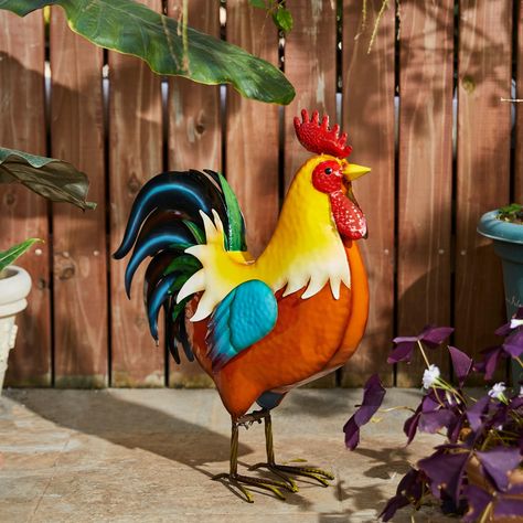 "Find the Glitzhome® 21\" Vibrant Standing Metal Rooster Garden Statue at Michaels. com. Add a touch of playful fun and country charm to your home or garden with this interesting and whimsical rooster statue. Add a touch of playful fun and country charm to your home or garden with this interesting and whimsical rooster statue. Crafted of high-quality powder-coated metal, it features handcrafted vibrant colors, lifelike textures and 3D details, providing a lively and aesthetic appearance. Details Metal Rooster Decor, Rooster Garden, Theme Garden, Gardening Backyard, Rooster Statue, Evergreen Garden, Metal Rooster, Metal Chicken, Garden Figurines