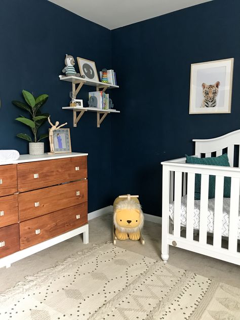 Dark wall nursery, moody nursery, navy blue nursery, boy nursery, safari nursery, tribal nursery, dark blue nursery, neutral nursery, wood tones nursery, tarva dresser hack Navy Wall Nursery, Navy Blue Nursery Gender Neutral, Dark Blue Kids Bedroom, Dark Blue Baby Room, Dark Wall Nursery, Dark Blue Nursery Boy, Navy Walls Nursery, Navy Safari Nursery, Dark Blue Nursery Ideas