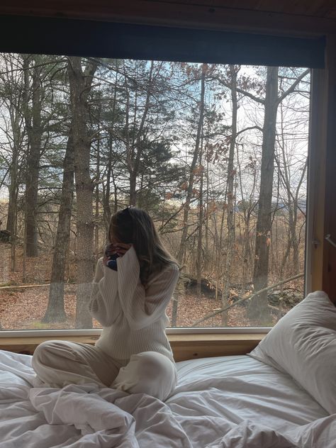 Sitting in front of a window overlooking the woods in winter ny  in a neutral style comfy style cozy winter aesthetic cabin H&M knit sweater and lounge pants very cozy style Cozy Winter Cabin Aesthetic, Cabin In The Woods Aesthetic, Winter Cabin Aesthetic, Cozy Cabin Aesthetic, Aesthetic Cabin, Cozy Winter Aesthetic, Cabin Outfit, Cozy Winter Cabin, Cabin Weekend