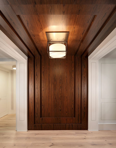 accent wall paneling, entry or any focal point This entry features a modern twist on wall paneling by creating a flush panel detail with a recessed groove. The rosewood feature wall seamless runs up the wall and across the ceiling. Trim/Ceiling Paint: Benjamin Moore OC-17 White Dove. #janisecooperdesign.com #rosewood #paneling #wallpaneling #entry #foyer as inspired by W Design Condo Interior Design, Entry Wall, Condo Interior, Wall Panel Design, Ceiling Detail, White Dove, False Ceiling Design, Coastal Interiors, Wood Ceilings