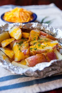 I went through a phase in my grilling education where I was convinced that you could cook almost anything in a foil packet. I've since moved on to other grilling obsessions, but potatoes have stayed firmly in their foil packets. Potatoes are quite possibly the perfect foil packet food, turning slightly crispy on the edges and tender on the inside. Adding a layer of melted cheese to these grilled potatoes near the end makes them irresistible! Grilled Potato Packets, Potato Packets, Vegetarian Bbq, Easy Camping Meals, Grilled Potatoes, Pita Chips, Cheesy Potatoes, Hash Browns, Tin Foil