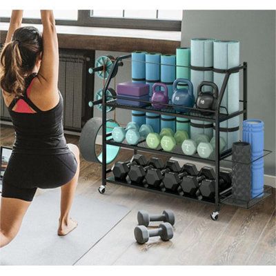 The sturdy sports storage rack is a convenient and ideal option for organizing your yoga equipment. It has three wide open shelves and two extra side storage areas, which should provide ample space for storing workout mats and other common sports accessories. | Arlmont & Co. Home Gym Storage Rack Black 36.0 x 54.0 x 15.0 in, Metal | Organization | C011141215 | Wayfair Canada Hidden Gym Storage, Home Gym Storage Ideas, Gym Storage Ideas, Gym Organization Ideas, Gym Organization, Sports Equipment Organization, Home Gym Storage, Gym Organizer, Gym Storage