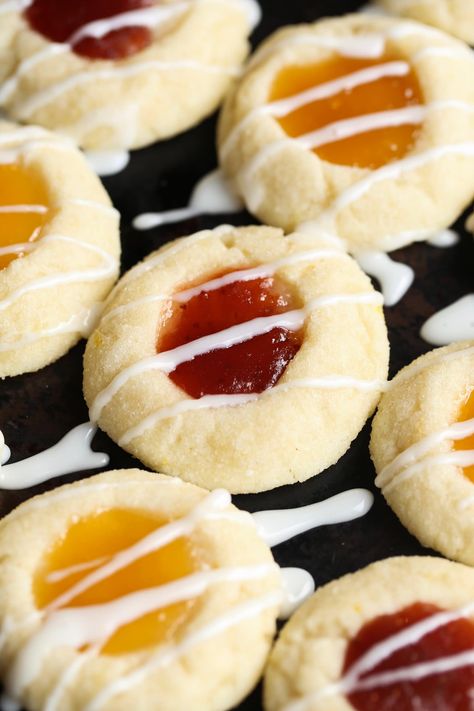 Lemon Thumbprint Cookies are a holiday staple! These easy cookies are sweet and tart with a melty texture. You will fall in love with this cute lemon cookies recipe! #lemon #thumbprint #cookies #lemoncookies #thumbprintcookies #lemoncookiesrecipe #thumbprintcookiesrecipe #easycookiesrecipe