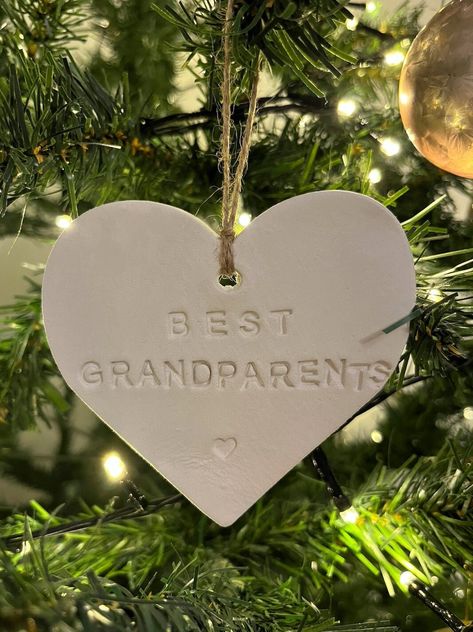 best grandparents clay heart decoration, perfect as a gift, hang it on the wall or as a decoration for your christmas tree! measures approx. 9.5cm x 9cm please note: made using air dry clay, imperfections may occur if you have any questions, just send me a message! Grace x Air Dry Clay Tree Ornaments, Air Dry Clay Ideas Christmas Decorations, Air Dry Clay Gifts For Mom, Air Dry Clay Ideas Christmas, Air Dry Clay Gift Ideas, Air Dry Clay Christmas Decorations, Air Dry Clay Ornaments, Christmas Presents For Grandparents, Air Dry Clay Christmas